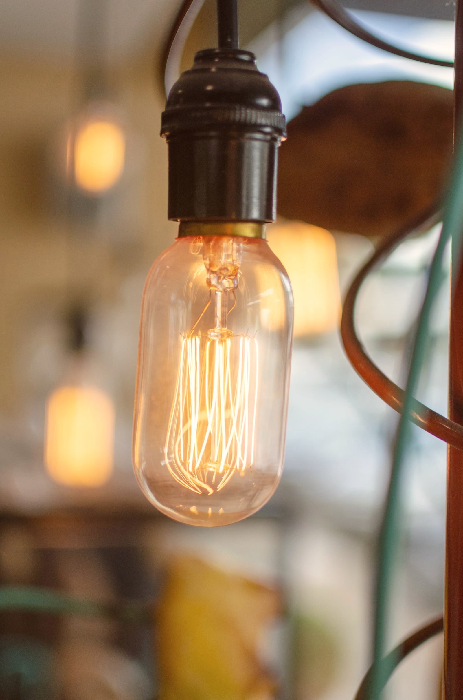 Carbon filament style bulb in a bakelite socket, glowing warm
