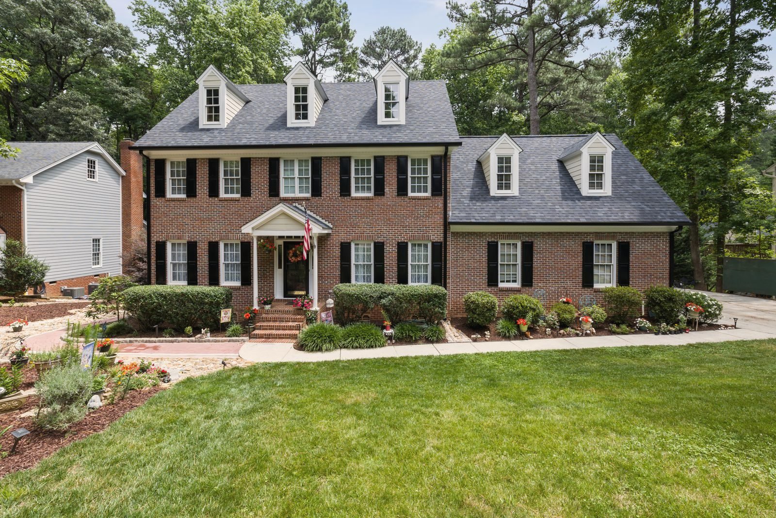 Brick colonial house with a deep front garden